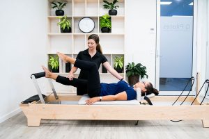 Pilates instructor demonstrating clinical exercise